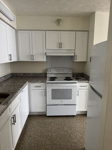 Worcester apartment for rent - A kitchen with white cabinets and a white stove top oven.