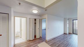 Malden apartment for rent - A spacious room with wooden floors and white walls.