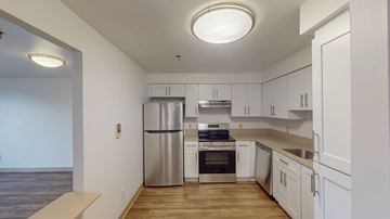 Malden apartment for rent - A kitchen with white cabinets and stainless steel appliances.