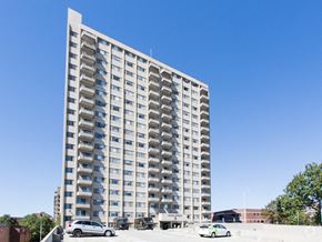 Malden apartment for rent - a tall apartment building with cars parked in front of it