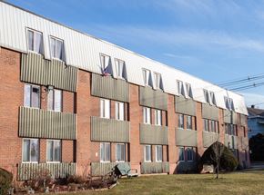 Wallingford apartment for rent - a brick building with a white roof and a grid of windows