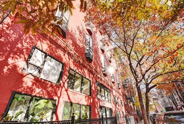 New York apartment for rent - a red building with a tree in front of it