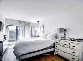 New York apartment for rent - a white bedroom with a bed and a dresser