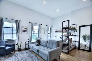 New York apartment for rent - a living room with a couch and a bed in a bedroom