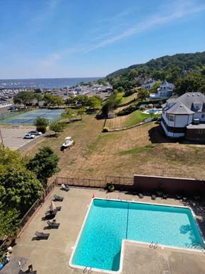 Atlantic Highlands apartment for rent - an aerial view of a pool and a house with a view of the ocean
