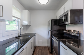 Norwich apartment for rent - A modern kitchen with black countertops and stainless steel appliances.