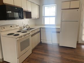 Norwich apartment for rent - an empty kitchen with white appliances and white cabinets