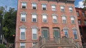 Norwich apartment for rent - the facade of a brick building with two balconies