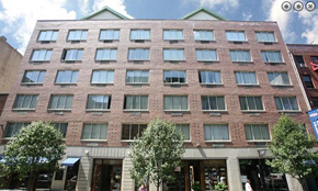 New York apartment for rent - a tall brick building with trees in front of it