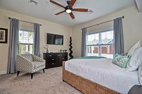 Tewksbury apartment for rent - A bedroom with a bed, chair, and a ceiling fan.