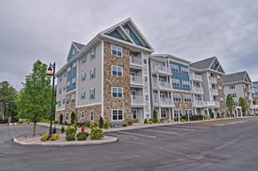 Tewksbury apartment for rent - A large apartment complex with a parking lot in front.