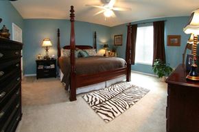 Leesburg townhouse for rent - a bedroom with a bed and a zebra rug