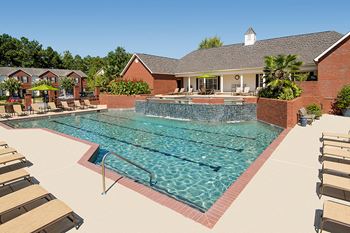 Two swimming pools including one with tiered waterfall