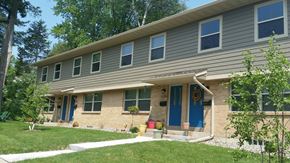 Madison townhouse for rent - a house with blue doors and a lawn