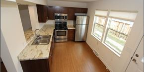 Madison townhouse for rent - a kitchen with stainless steel appliances and marble counter tops