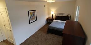 Madison townhouse for rent - a bedroom with a bed and a dresser in it