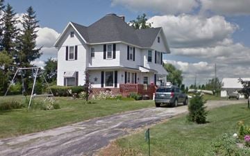 Arlington apartment for rent - A white house with a grey roof and a red door.