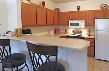 Waunakee apartment for rent - a kitchen with a counter with two chairs