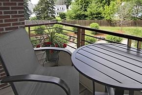 Waunakee apartment for rent - a patio with a table and chairs on a balcony