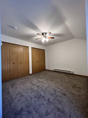 Reedsburg apartment for rent - A room with a ceiling fan and two doors.