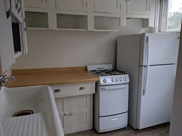 Madison apartment for rent - a small kitchen with a stove refrigerator and sink