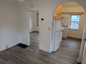 Madison apartment for rent - an empty kitchen and living room with a refrigerator