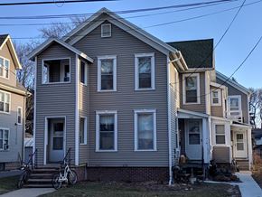 Madison apartment for rent - a gray house with a bike parked in front of it