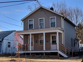 Madison apartment for rent - a gray house with a porch and a white house next to it