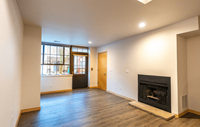 Madison apartment for rent - A living room with a fireplace and a large window.