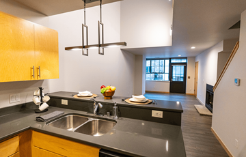 Madison apartment for rent - A modern kitchen with a black counter top and wooden cabinets.
