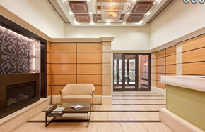 New York apartment for rent - a lobby with a fireplace and a chair and a table