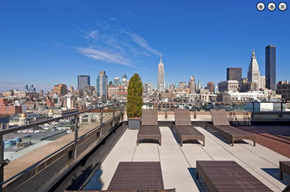 New York apartment for rent - a group of benches on a roof overlooking a city