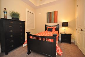 Durham apartment for rent - a bedroom with a bed and a dresser and a window