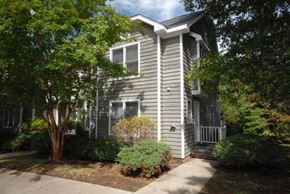 Durham apartment for rent - a gray house with a sidewalk and trees