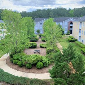 Durham apartment for rent - an aerial view of a courtyard with trees and a picnic table