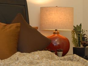 Durham apartment for rent - a bed with pillows and a lamp on top of it