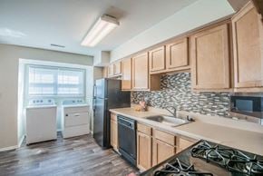 Windsor Mill townhouse for rent - a kitchen with wooden cabinets and a stove and a sink