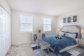 Windsor Mill townhouse for rent - a bedroom with a bed and two windows