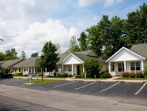 Ashtabula apartment for rent - A row of white houses with green lawns in front.