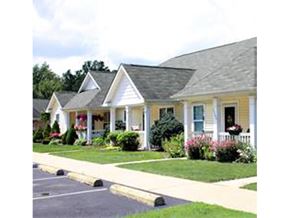 Ashtabula apartment for rent - A yellow house with a grey roof and a white picket fence.