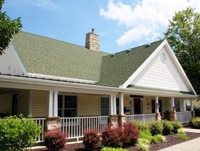 Ashtabula apartment for rent - A small house with a green roof and a white fence.