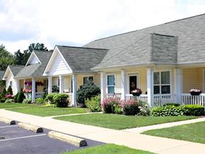 Ashtabula apartment for rent - A row of houses with white front porches and flower boxes.