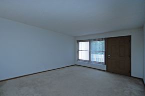 Bloomington townhouse for rent - an empty living room with a window and a door