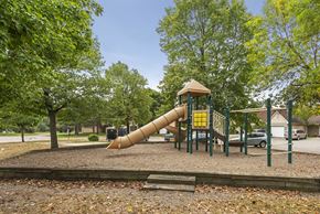 Bloomington townhouse for rent - a playground with a slide in a park