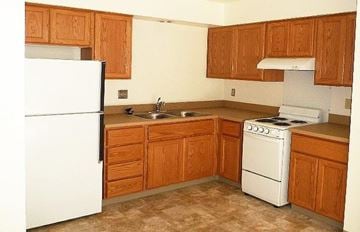 Lewiston apartment for rent - a small kitchen with a stove refrigerator and sink