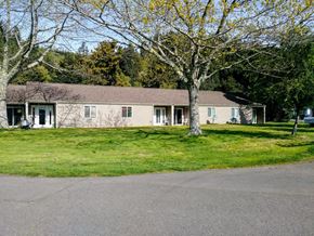 Reedport apartment for rent - a white house with a tree in front of it