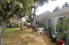 Reedport apartment for rent - a backyard with a table and chairs and a house