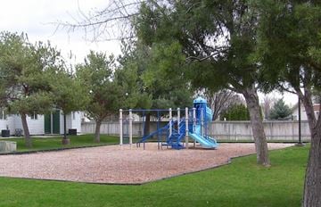 Nampa apartment for rent - a blue playground in a park with trees