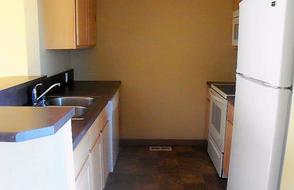 Cutbank apartment for rent - Kitchen with Fridge, Range, and Microwave