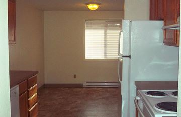 Beaverton apartment for rent - an empty kitchen with a stove and a refrigerator